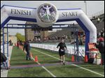  Ann Fleck, 75, of Toledo, finishesing the half marathon.