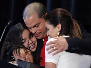 Daughters Ivanna, left, and Amanda support Ivan Rodriguez after he announced Monday he was retiring. He was a 14-time all-star.