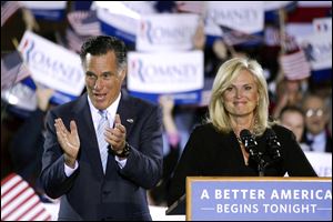 Republican presidential candidate, former Massachusetts Gov. Mitt Romney, left, and his wife, Ann, take the stage at an election night rally in Manchester, N.H., Tuesday.