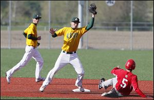 Oregon Clay's JJ Miller (4) makes a play against Central Catholic's Derek Hafner (5) at second base during the first inning at Mercy Field in Toledo.