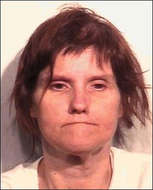 Susan Carter, 43, seen here in a recent booking photo, was found dead Tuesday morning on a bench outside the downtown library.