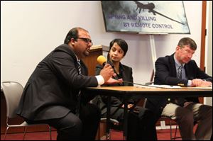 Attorney Shahzad Akbar, left, speaks at a conference organized by the anti-war group Code Pink as Hina Shamsi of the American Civil Liberties Union and David Glazier of the Loyola law school listen. Mr. Akbar showed photos of Pakistani victims of predator drones.
