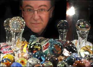 John Conklin displays more than 300 marbles and glass spheres in a lighted curio cabinet in his rural Whitehouse home.