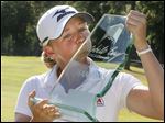  Stacy Lewis gives her trophy a kiss after winning the Mobile Bay LPGA Classic at the Magnolia Grove's Crossing golf course. 