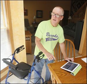 Tim Brooks, 54, who is retired from FirstEnergy Corp., uses a walker to get around and continues to fish and do other activities. His case of ALS is among the roughly 10 percent involving a gene abnormality shared by family members.