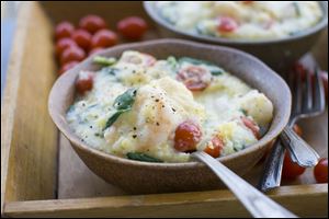 Cookbook author Nathalie Dupree's Shrimp and Grits with spinach and tomatoes recipe is shown.