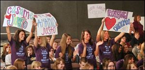 Students from Rossford High School cheer for Argentine singer Justo Lamas as he performs at Genoa High School.
