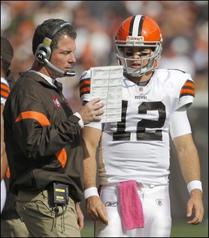 Colt McCoy consults with coach Pat Shurmur during a game last season. McCoy has been 6-15 as the Browns' starter the last two seasons, but his reign as starter appears to be over in Cleveland with the drafting of Brandon Weeden.