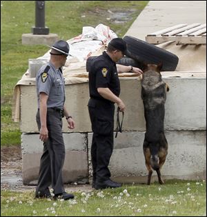 A bomb-sniffing dog and law-enforcement personnel search the grounds of the Toledo Correctional Institution, to which several anonymous threats were made. The lockdown order was lifted Tuesday evening after nothing unusual was found.