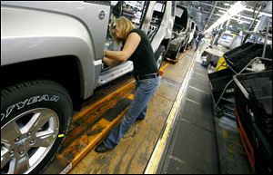 Pam Bialecki works on a 2012 Jeep Wrangler at the Chrysler Toledo Assembly complex in November.
