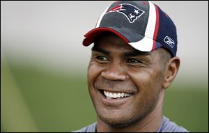 New England Patriots linebacker Junior Seau smiles during NFL football training camp in Foxborough, Mass. Police responded to a report of a shooting at the Seau's home in Oceanside, Calif.