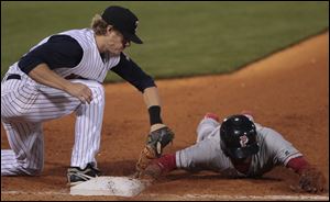 Mud Hens first baseman Rawley Bishop slaps the tag on Pawtucket’s Tony Thomas a little too late during a pickoff attempt Tuesday night at Fifth Third Field. The two teams will meet again today at 6:30 p.m.