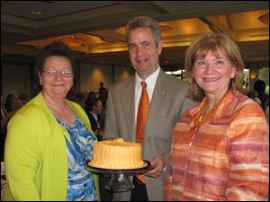 Sunsations for Sunset Retirement Communities was a hit, thanks in part to Kathleen Ausmus, left, who made cakes for the benefit. With her are Paul Johnson, board chairman, and Vicky Bartlett, president and CEO.