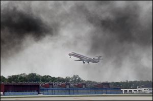 An American Eagle flight to Chicago flies over the  tarmac during a disaster drill.