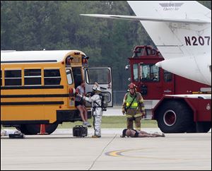Volunteer 'passengers' — their ranks drawn from among airport employees, their friends, and local high school students — were evacuated, with some loaded onto ambulances, a few carried away aboard medical helicopters, and some declared dead at the scene.