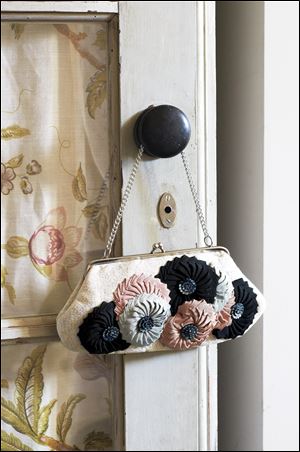 A purse with flowers made with pleated Petersham ribbon.