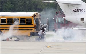 A school bus was a prop, substituting for a passenger plane, in a disaster drill at Toledo Express Airport.  Federal law requires a disaster drill at least every three years at the western Lucas County airport.