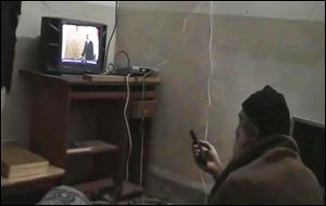 A man, identified as Osama bin Laden, watches President Barack Obama on television, in this undated video image seized from the al-Qaida leader's walled compound in Abbottabad, Pakistan.