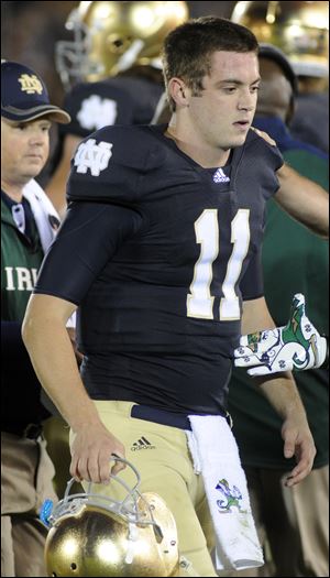 Notre Dame quarterback Tommy Rees walks off the field after being injured in an Oct. 22, 2011, game in South Bend, Ind.