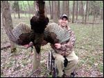  Mike McCloskey, Jr., beams as he shows off a 22-pound wild turkey he took during the hunt on the grounds of Toledo Express Airport.