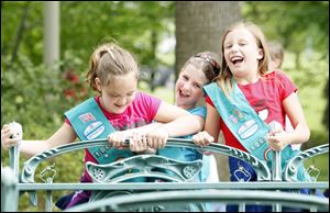 lly King, left, Shaelyn Kiser, and Sophie King from the Girl Scouts of Western Ohio Troop 10036 play on the metro sculpture in front of the museum during the 100th birthday celebration.  Some 1,600 girls planned to sleep in the museum Saturday night.