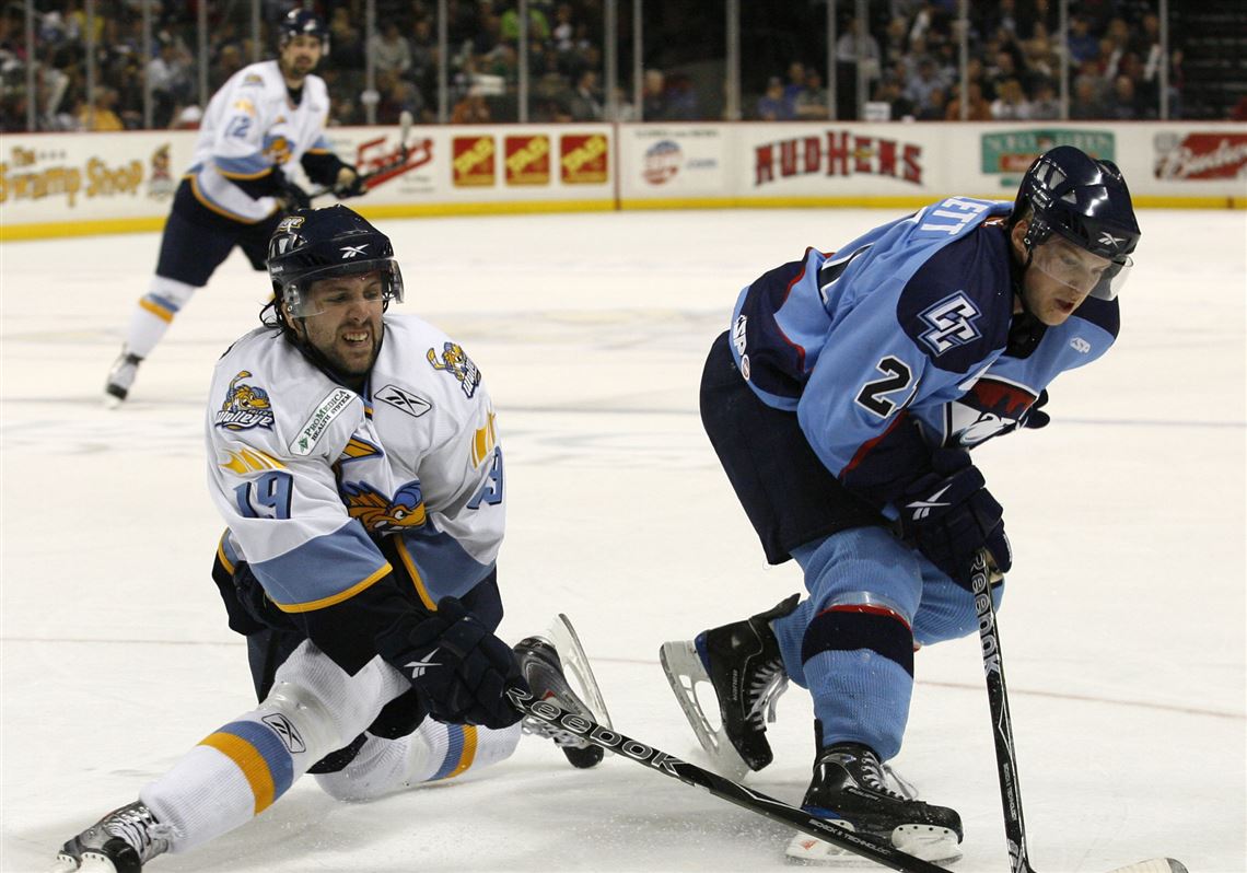 The Walleye’s Sal Peralta, left, battles Charlotte’s Mike Bartlett in an ECHL game April 7, 2010, at the Huntington Center. The Checkers moved to the American Hockey League the next season.