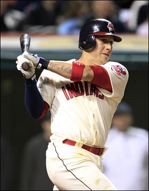 The Indians' Asdrubal Cabrera hits an RBI-double off Rangers relief pitcher Mike Adams in eighth inning.