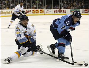 The Walleye’s Sal Peralta, left, battles Charlotte’s Mike Bartlett in an ECHL game April 7, 2010, at the Huntington Center. The Checkers moved to the American Hockey League the next season.