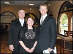  Lourdes President Bob Helmer, left, and wife Linda stand with student speaker Tim Berta at Luminations.