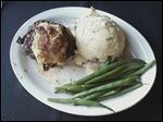  Rockwell’s Surf and Turf includes a 7-ounce prime grade top sirloin served with a crab cake, mashed potatoes, and green beans.