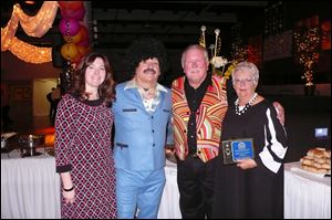 From left: East Toledo Family Center's executive director Kim Partin poses with distinguished citizen awardees George Marshall and Dick and Sandy Fisher at the Disco Fever Gala.