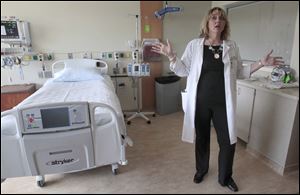 Kelly Joseph, a registered nurse and stroke care coordinator at Toledo Hospital, shows off a patient room. Its 'telemedicine' technology allows doctors to examine and treat patients quickly. 
