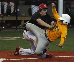 Bowsher pitcher Jacob Almanza stops Clay’s Tyrus McAtee short of the plate in Wednesday’s sectional final.