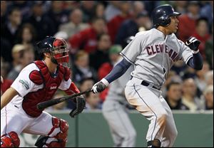 Cleveland Indians' Michael Brantley, right, hits a two-run double in front of Boston Red Sox catcher Kelly Shoppach in the third inning Thursday night.