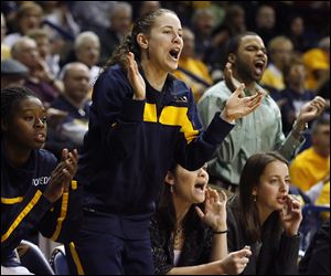 University of Toledo guard Naama Shafir cheers from the bench during a game this season. Shafir will return next season, but UT was given a scholarship waiver to cover her fifth season.