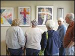  Chris Rilling, right, chairman of the Community of Christ Lutheran Church’s arts committee, joins members of the Whitehouse church’s craft club at the Visions from the Heart show. The exhibit of liturgical works by 14 artists runs through May 20 at the church, 6517 Finzel Rd.