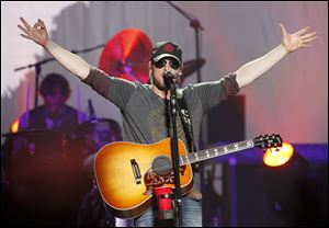 Singer Eric Church welcomes the Toledo-area crowd to his show at the Huntington Center Thursday night.