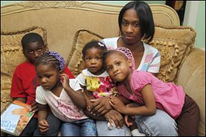 LaSonya Jelks and her kids from left: Michael McDuffey, 9, Ronnae Davis, 2, Reyvan Davis, 9 months, and Peyton Jelks, 5, in their Toledo, Ohio home.