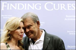 Country singer Glen Campbell, who has Alzheimer's disease, stands with his wife Kim during a news conference on Capitol Hill in Washington, Tuesday.