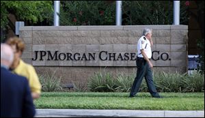 Hillsborough Sheriff deputy patrols outside the gate of JP Morgan Chase annual stockholders meeting held Tuesday, in Tampa, Fla. JPMorgan Chase CEO Jamie Dimon will speak to shareholders five days after disclosing a $2 billion trading loss.