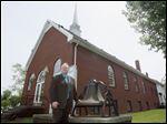  The Rev. David Stogsdill stands in front of Grace Bible Baptist Church, one of the oldest structures in Walbridge. The church, on Union Street, was built in 1890. 