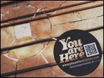  This dot in front of the Valentine Theatre in downtown Toledo is one of 100 dots that are part of the 'You Are Here' project.