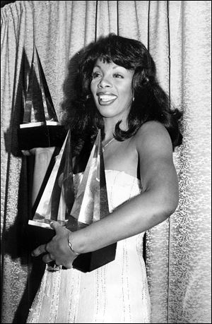 In this Jan. 12, 1979, photo, Donna Summer poses with three awards she won at the American Music Awards in Los Angeles.