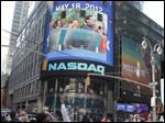  People in New York's Times Square watch Nasdaq's giant monitor as Facebook's stock begins trading on the Nasdaq stock market in New York.