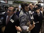  Traders work on the floor of the New York Stock Exchange during Thursday's session. Stocks slipped in early activity as discouraging economic reports further unnerved traders already concerned about a possible exit from the euro by Greece. The Dow lost 156.06 points, most toward the day's end.