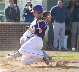 Maumee’s David McCrum scores as Norwalk catcher Dustin Lieber takes the throw in the fourth inning. Th e Panthers are 17-9.