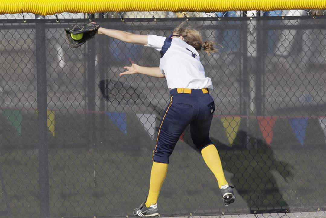 NDA-left-fielder-Molly-Walters-makes-a-catch-at-the-wal