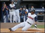  The Mud Hens’ Eric Patterson slides into home after he hits an inside-the-park home run in the third inning against Scranton/Wilkes-Barre on Friday. Toledo battled back from a 7-0 deficit in the third inning only to lose 9-8.