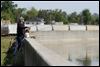  Dan Engel of Cincinnati uses a stepladder to fish at a wall along the Sandusky River in downtown Fremont.