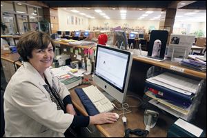 Cindy Bramson, librarian at Maumee High School, is losing her job after 33 years because of budget-balancing moves.